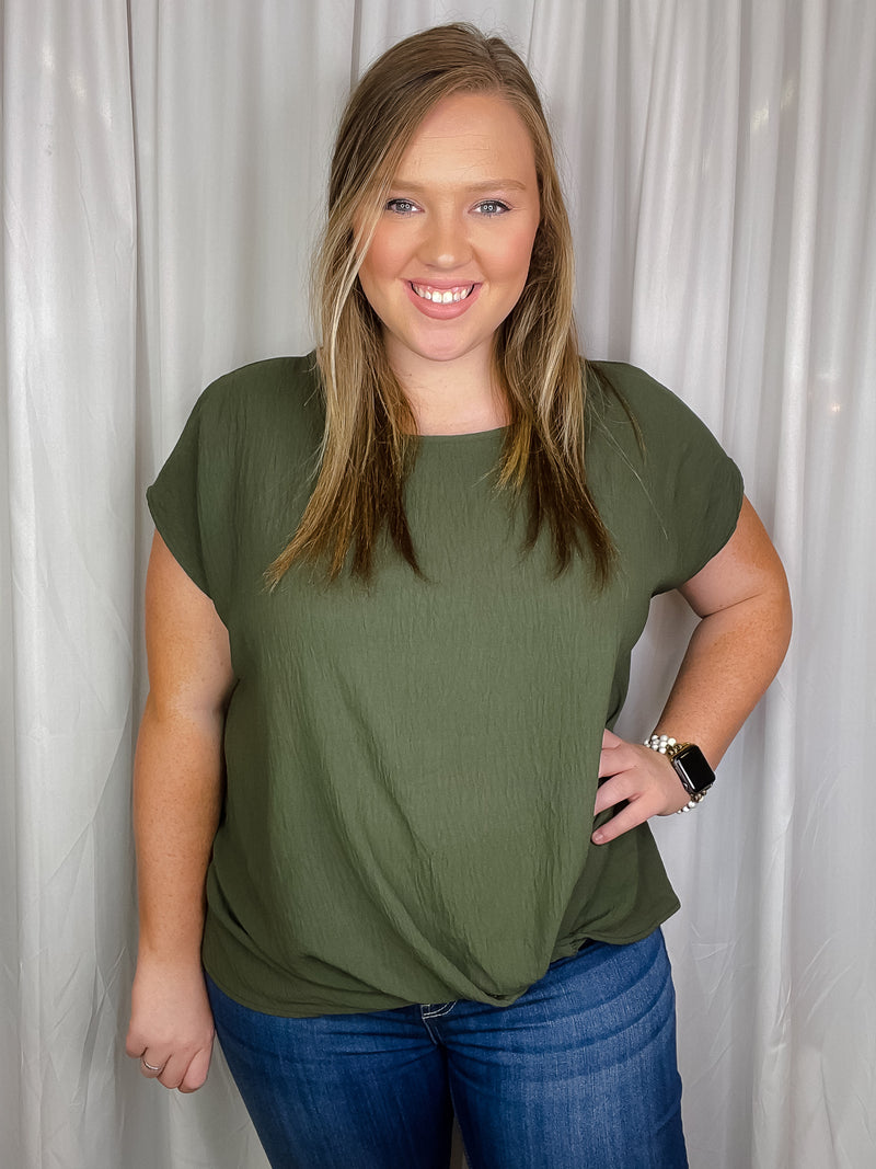 Top features a solid base color, short sleeves, round neck line, front knot detail, and runs true to size! 