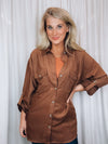 Top features a solid brown color, long roll up sleeves, button down detail, soft material and runs true to size! 