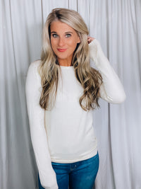 Top features a solid base color, round neck line, long sleeves, soft material and runs fitted!-VANILLA