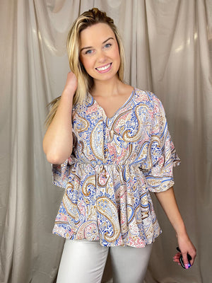 Top features a white base, multi color printed design, short sleeves, dolman sleeves, elastic waist line and runs true to size! 