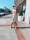 Dress features a solid base color, midi length, soft ribbed material, sleeveless detail, round neck line, wrap detail and runs true to size!-taupe