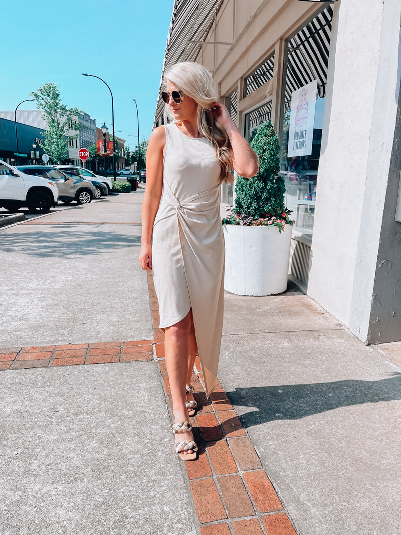Dress features a solid base color, midi length, soft ribbed material, sleeveless detail, round neck line, wrap detail and runs true to size!-aupe