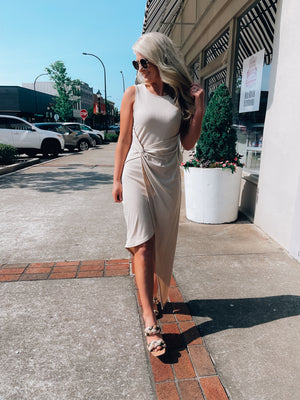 Dress features a solid base color, midi length, soft ribbed material, sleeveless detail, round neck line, wrap detail and runs true to size!-taupe