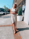 Dress features a solid base color, midi length, soft ribbed material, sleeveless detail, round neck line, wrap detail and runs true to size-taupe