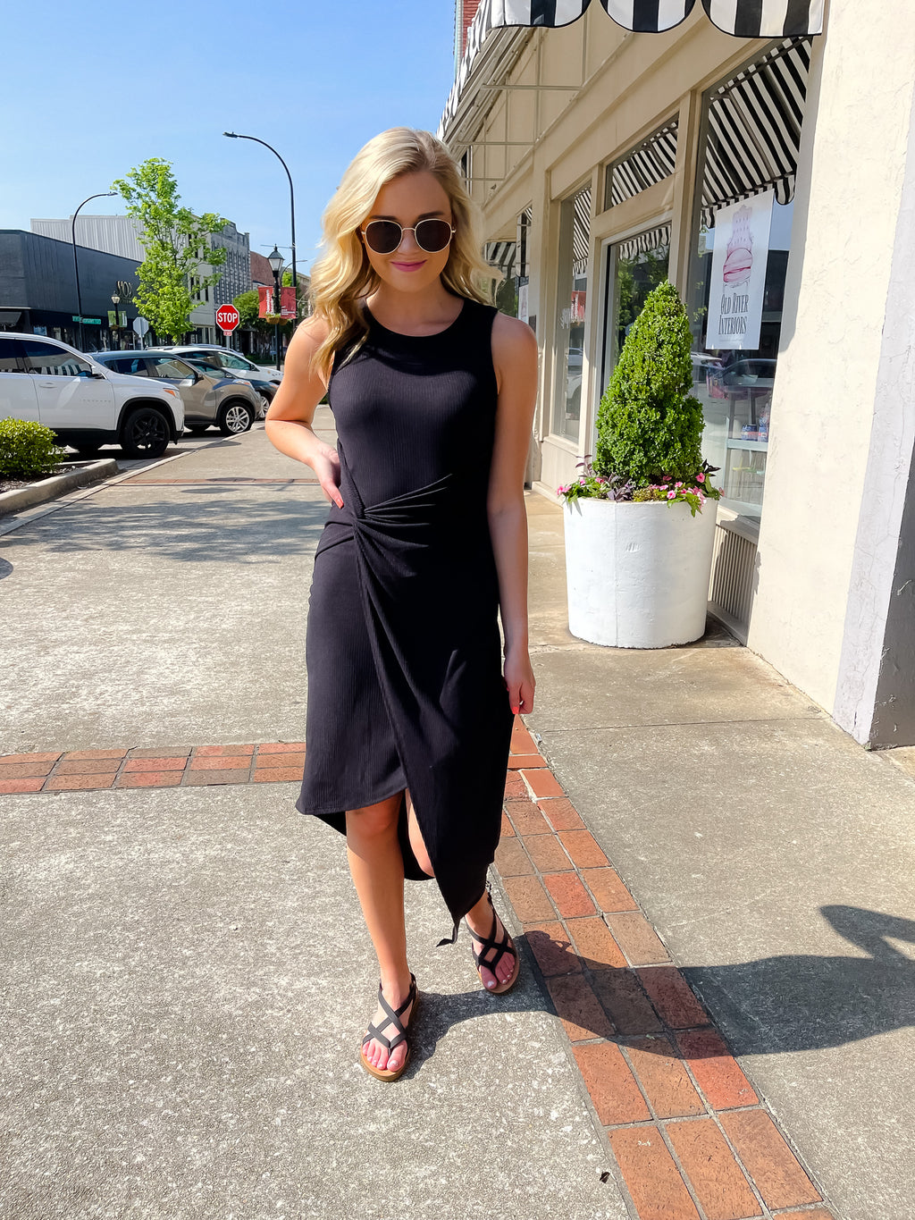 Dress features a solid base color, midi length, soft ribbed material, sleeveless detail, round neck line, wrap detail and runs true to size! -black