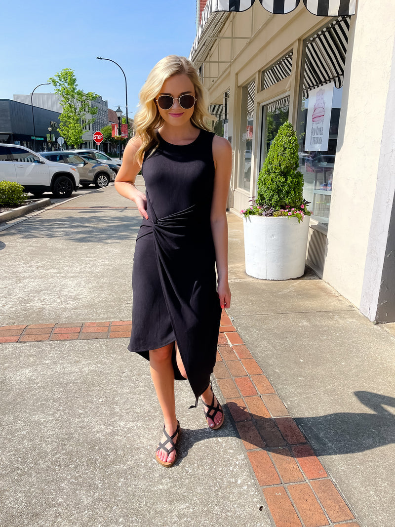 Dress features a solid base color, midi length, soft ribbed material, sleeveless detail, round neck line, wrap detail and runs true to size!-aupe