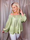 Top features a solid base color, off the shoulder detail, loose fit elastic cuff and runs true to size! 