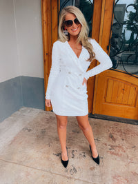 Dress features a white full sequin base, long sleeves, deep V-neck line, back zipper closure, faux double button front detailing, mini length and runs true to size! 