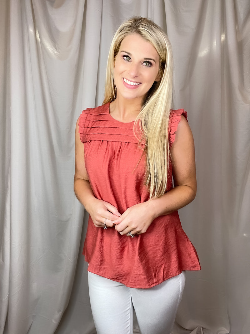 Top features a solid base color, sleeveless detail, round neck line, detailing on the chest, lightweight material and runs true to size!-hunter green