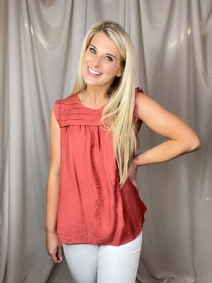 Top features a solid base color, sleeveless detail, round neck line, detailing on the chest, lightweight material and runs true to size!-marsala