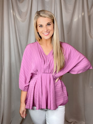 Top features a mauve color, V-neck line, kimono sleeves, fitted waist, lightweight material, flattering fit and runs true to size! 