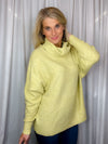 Sweater features a citrus color, long dolman sleeves, mock neck line, soft material and runs true to size