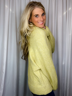 Sweater features a citrus color, long dolman sleeves, mock neck line, soft material and runs true to size