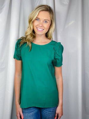 Top features a solid base color, round neck line, ruffle detailed short sleeve and runs true to size! 