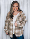 Shacket features a taupe color plaid print, long sleeves, functional button closure, hood detail, frayed hem detail and runs true to size! 
