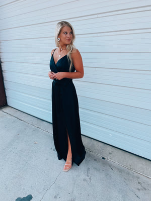 Black satin maxi includes a V-neck wrap design, adjustable straps, and high slit detail, creating the perfect combination of elegant yet oh so sexy! Runs true to size!