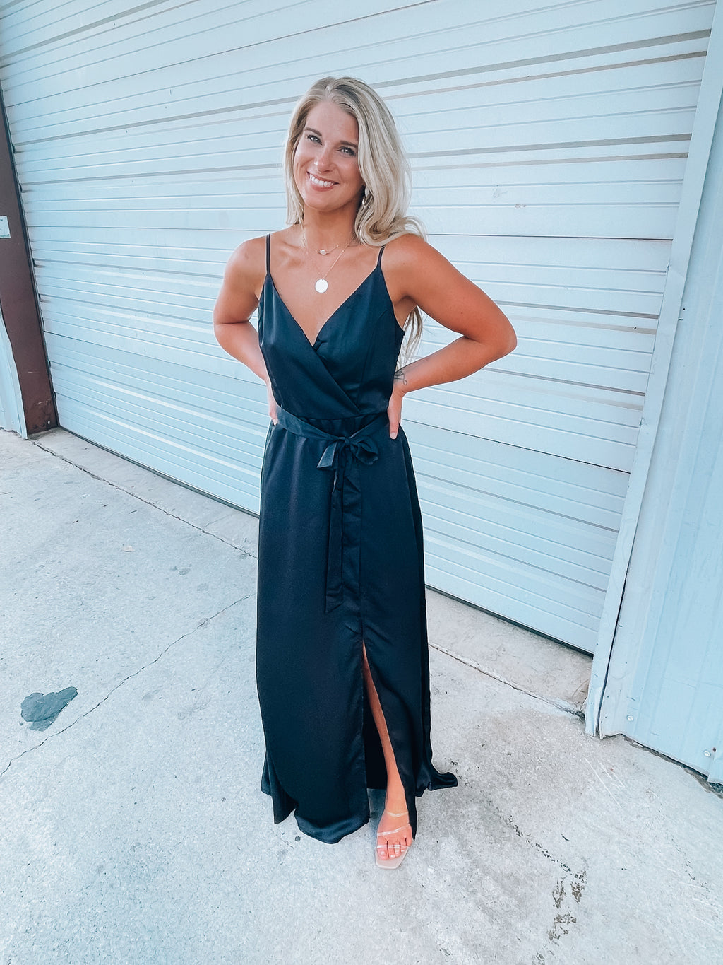 Black satin maxi includes a V-neck wrap design, adjustable straps, and high slit detail, creating the perfect combination of elegant yet oh so sexy! Runs true to size!