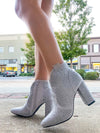 Booties feature a solid colored base, full rhinestone detailing, side zip- up detail, 3.5 heel, and runs true to size!-silver