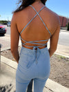 Jumpsuit features a light wash denim, lace up back detail, flattering fit, sleeveless detail, halter neck line and runs true to size! 