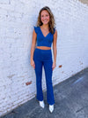 Two piece set features a medium denim wash, flare bottoms, crop top with ruffle sleeves, V-neck line, zip up top and bottom detail and runs true to size! 