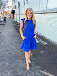 Dress features a stunning royal blue color, ruffle hem line detail, elastic waist, tie belt addition, functional pockets and runs true to size! 