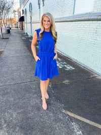 Dress features a stunning royal blue color, ruffle hem line detail, elastic waist, tie belt addition, functional pockets and runs true to size! 