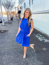 Dress features a stunning royal blue color, ruffle hem line detail, elastic waist, tie belt addition, functional pockets and runs true to size! 