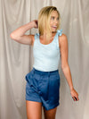 Shorts feature a base color with a silky detail and metal clasp. Runs true to size!