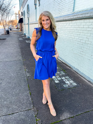 Dress features a stunning royal blue color, ruffle hem line detail, elastic waist, tie belt addition, functional pockets and runs true to size! 