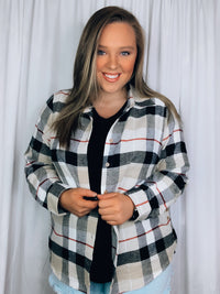 Flannel features a dark black and cream plaid detail, long sleeves, open front detail, collared detail, button up detail and runs true to size!