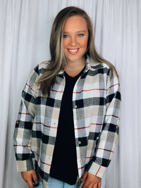 Flannel features a dark black and cream plaid detail, long sleeves, open front detail, collared detail, button up detail and runs true to size!