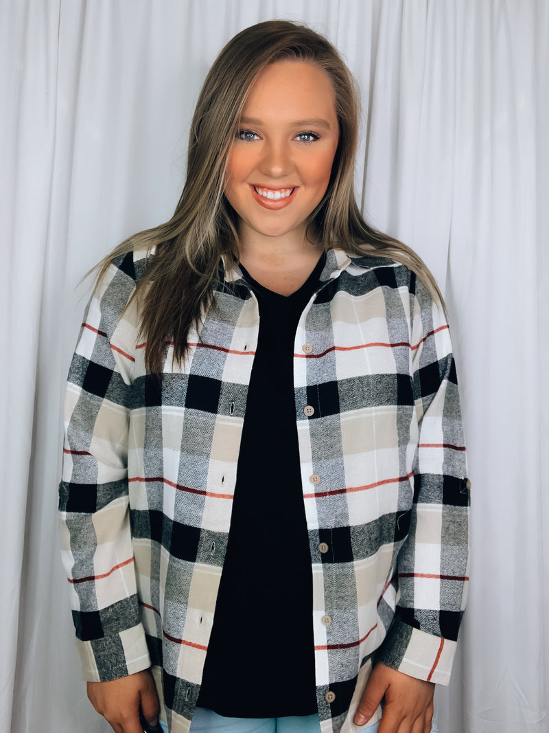 Flannel features a dark black and cream plaid detail, long sleeves, open front detail, collared detail, button up detail and runs true to size!