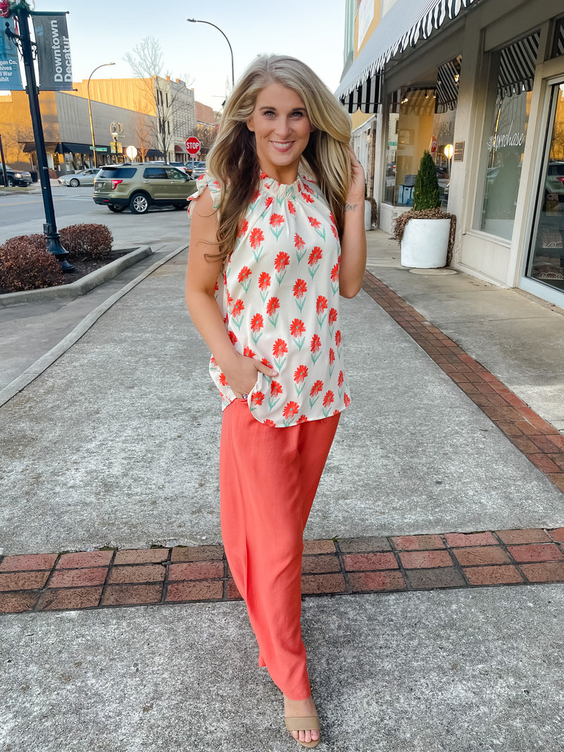 Top features an ivory base, mint/coral floral print design, ruffle high neck line, ruffle cap sleeves, light weight material and runs true to size! 