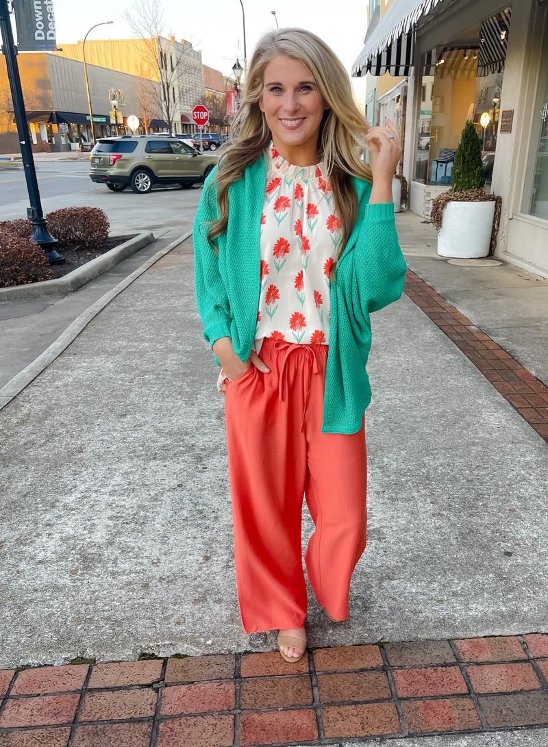 Top features an ivory base, mint/coral floral print design, ruffle high neck line, ruffle cap sleeves, light weight material and runs true to size! 