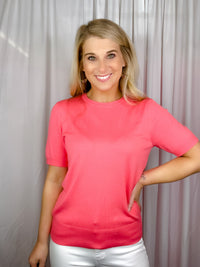 Top features a solid base color, crew neck line, short sleeves, and runs true to size!-coral