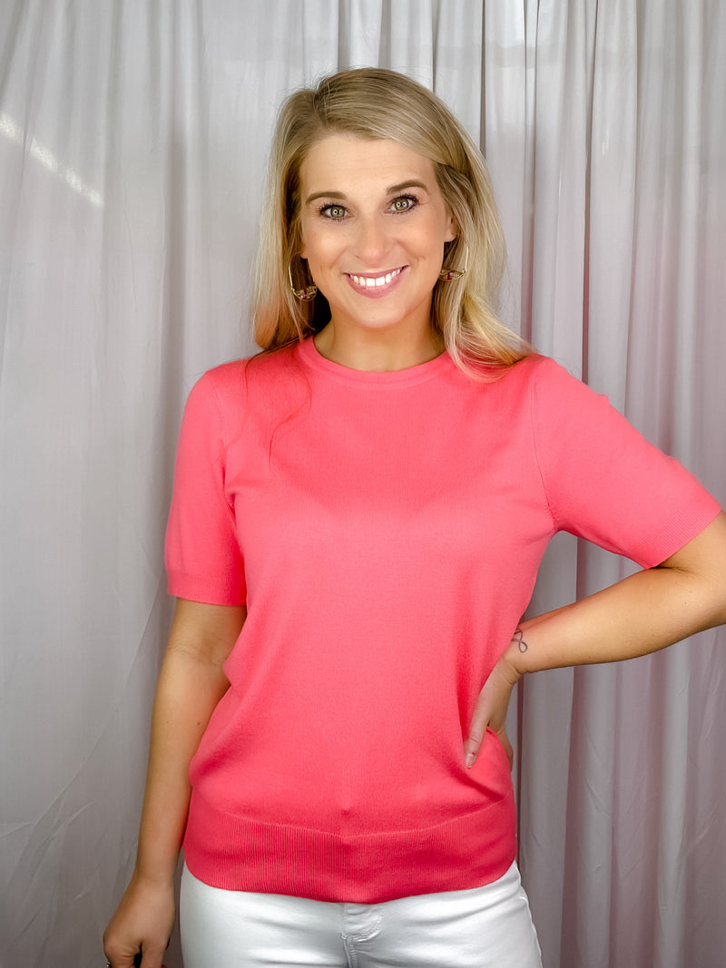 Top features a solid base color, crew neck line, short sleeves, and runs true to size!-coral