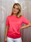 Top features a solid base color, crew neck line, short sleeves, and runs true to size!-coral