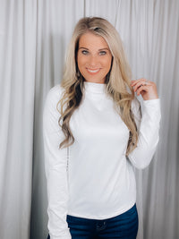 Top features a solid base color, long sleeve, mock neck line, fitted fit, and runs true to size! 