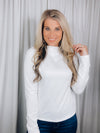 Top features a solid base color, long sleeve, mock neck line, fitted fit, and runs true to size! 