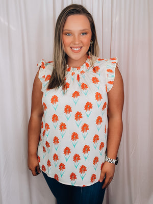 Top features an ivory base, mint/coral floral print design, ruffle high neck line, ruffle cap sleeves, light weight material and runs true to size! 