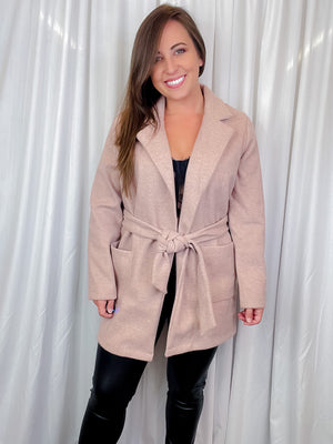 Coat features a solid base color, long sleeves, tie waist band, open front detail, collar detail, and runs true to size! -blush