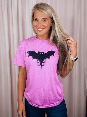 Graphic features a solid base colored tee, short sleeves, unisex fit, distressed black design and runs true to size!-pink