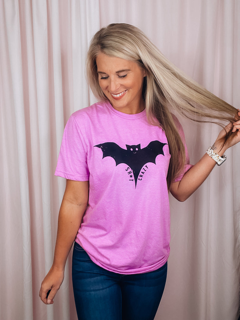 Graphic features a solid base colored tee, short sleeves, unisex fit, distressed black design and runs true to size!-pink