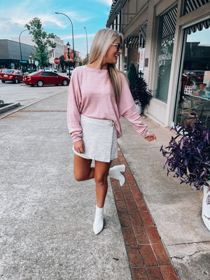 Top features a light pink color, long sleeves, round neck line, oversized fit, horizontal texture detail and runs true to size! 
