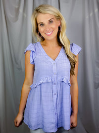 Top features a lilac color, textured detail, functional button down detail, V-neck line, short sleeves and runs true to size! 