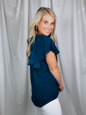 Top features a solid base color, stretchy material, short ruffle sleeves, round neck line and runs true to size!-navy