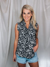 Top features a solid base color, floral print detail, sleeveless ruffle top, ruffle neck line and runs true to size!-black