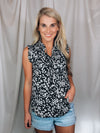 Top features a solid base color, floral print detail, sleeveless ruffle top, ruffle neck line and runs true to size!-black