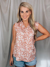 Top features a solid base color, floral print detail, sleeveless ruffle top, ruffle neck line and runs true to size!-mauve
