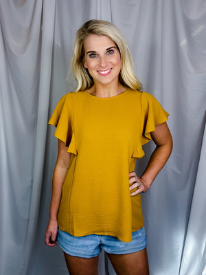 Top features a solid base color, stretchy material, short ruffle sleeves, round neck line and runs true to size!-mustard